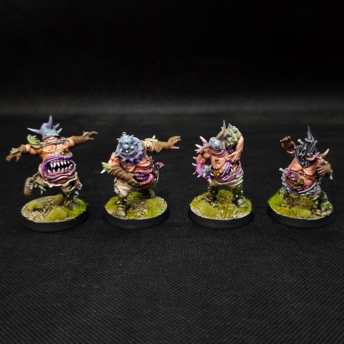 Fantasy Football tabletop miniatures showcasing four painted Rottens for the Plague Chaos Team.