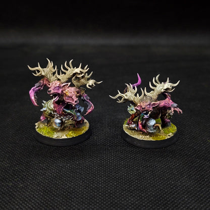Fantasy football tabletop miniatures featuring two detailed Plague Chaos Team RotSpawn figures on black bases.
